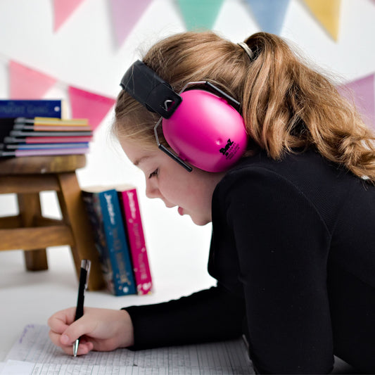 Child wearing Banz Hear No Blare Earmuffs Ear Defenders in Pink