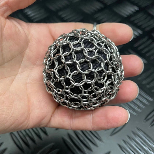 Hand holding a Chain Maille picking support ball in small size by Kaiko Fidgets