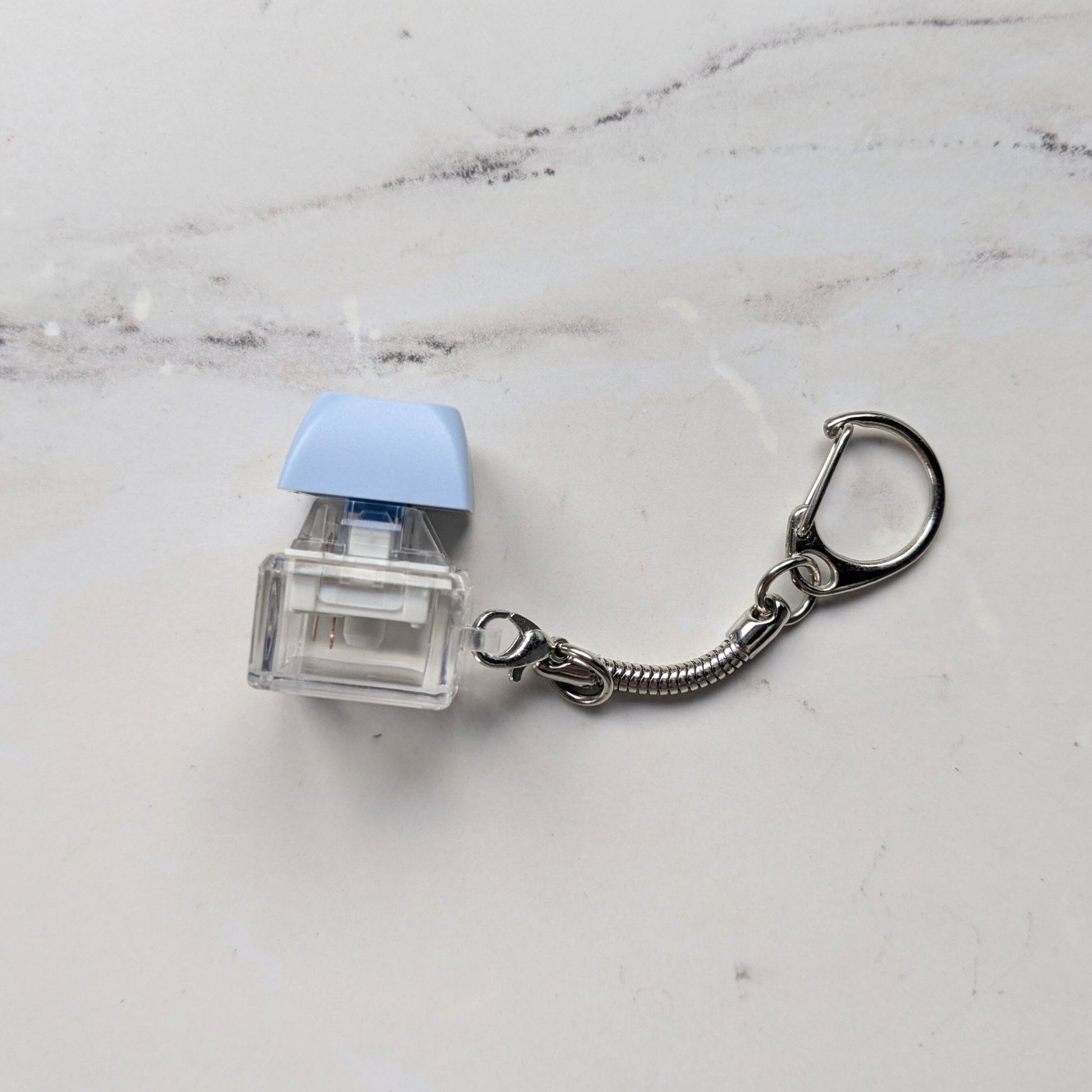 Side view of Clicky Keychain Keycap Fidget in Blue
