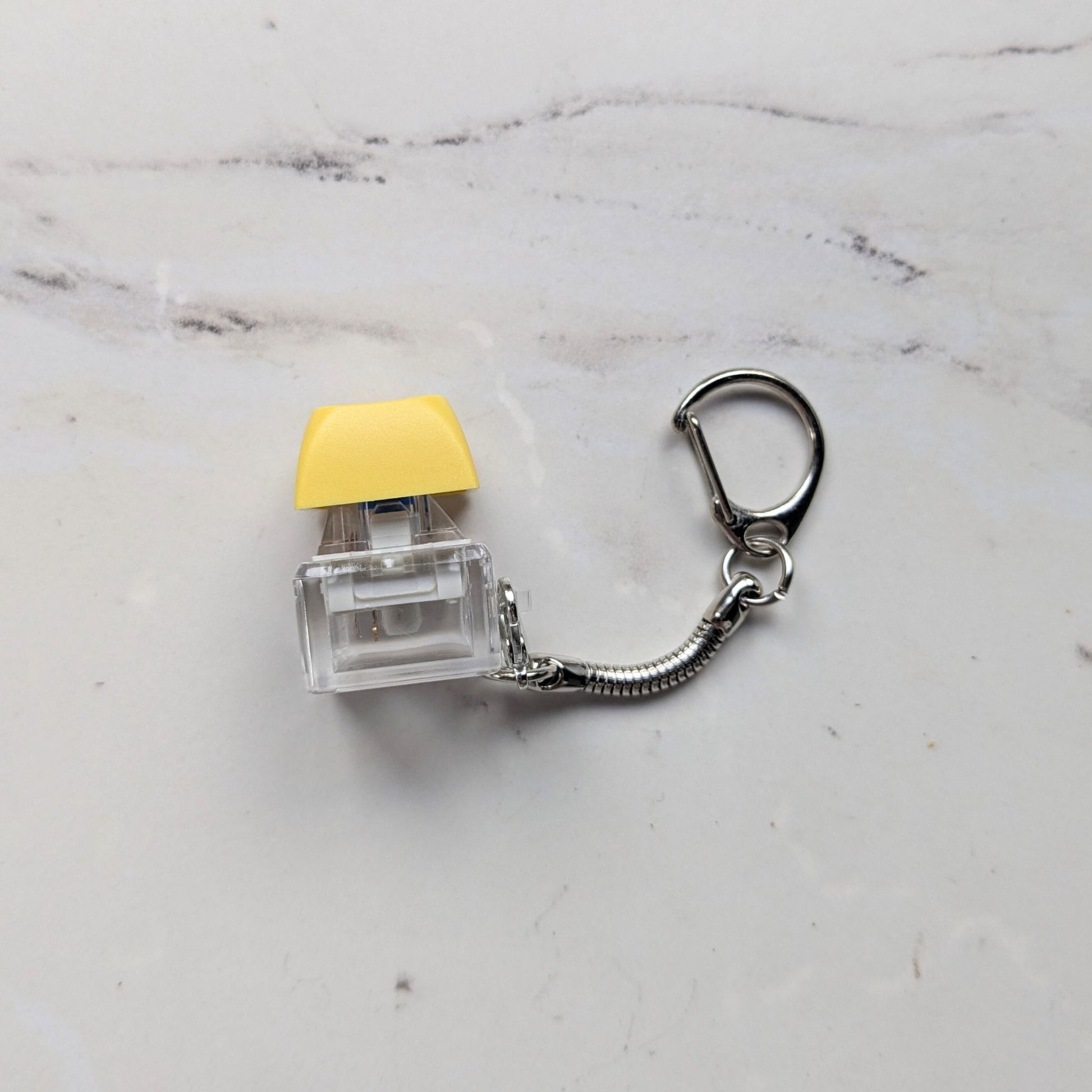 Side view of Clicky Keychain Keycap Fidget in Yellow