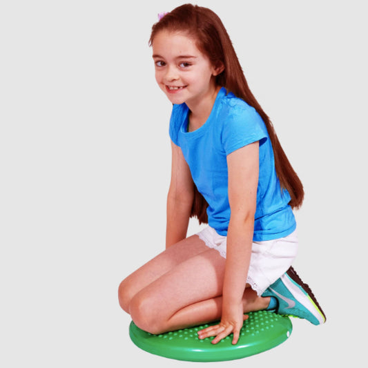 Girl sitting on Elizabeth Richards Wriggle Cushion in Green