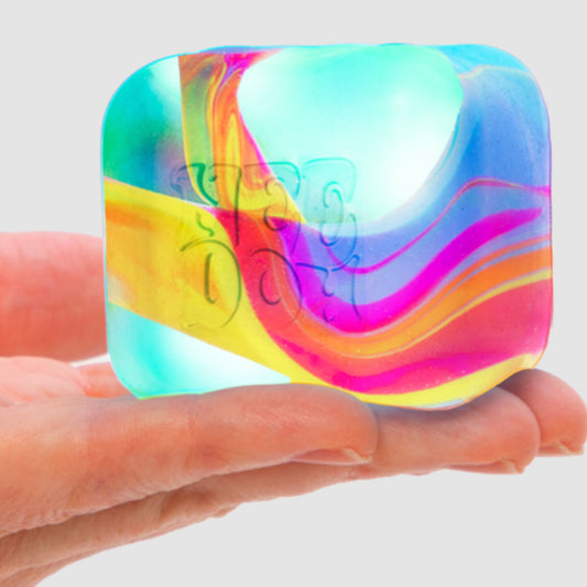 A colourful Needoh Nice Cube Swirl marbled squishy cube on a white background