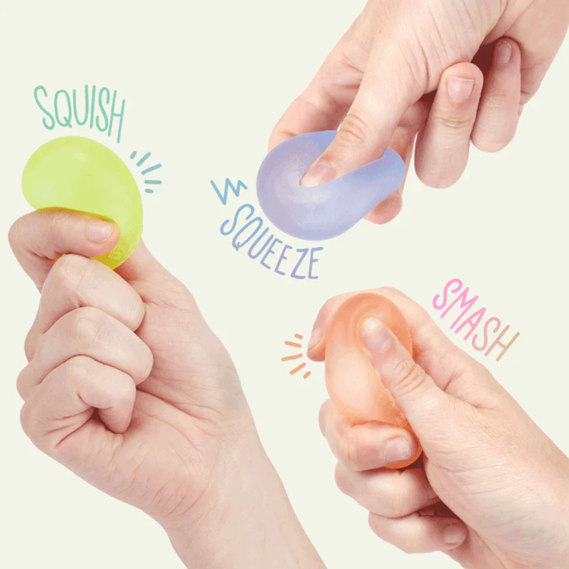 Three hands holding colourful Gump mini stress balls labeled 'Squish', 'Squeeze', and 'Smash' on a light background.