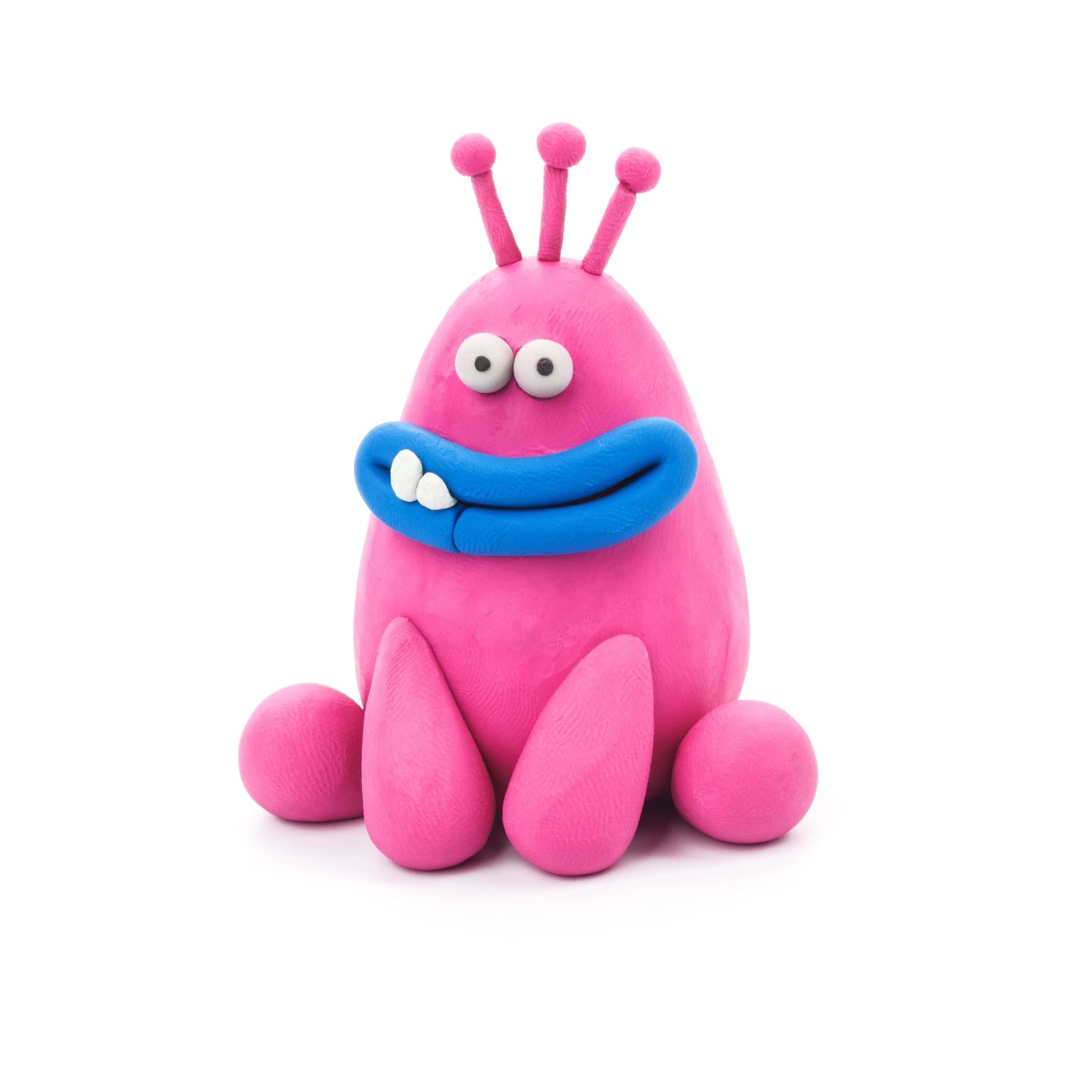 Pink monster made of Hey Clay air-dry clay on a white background