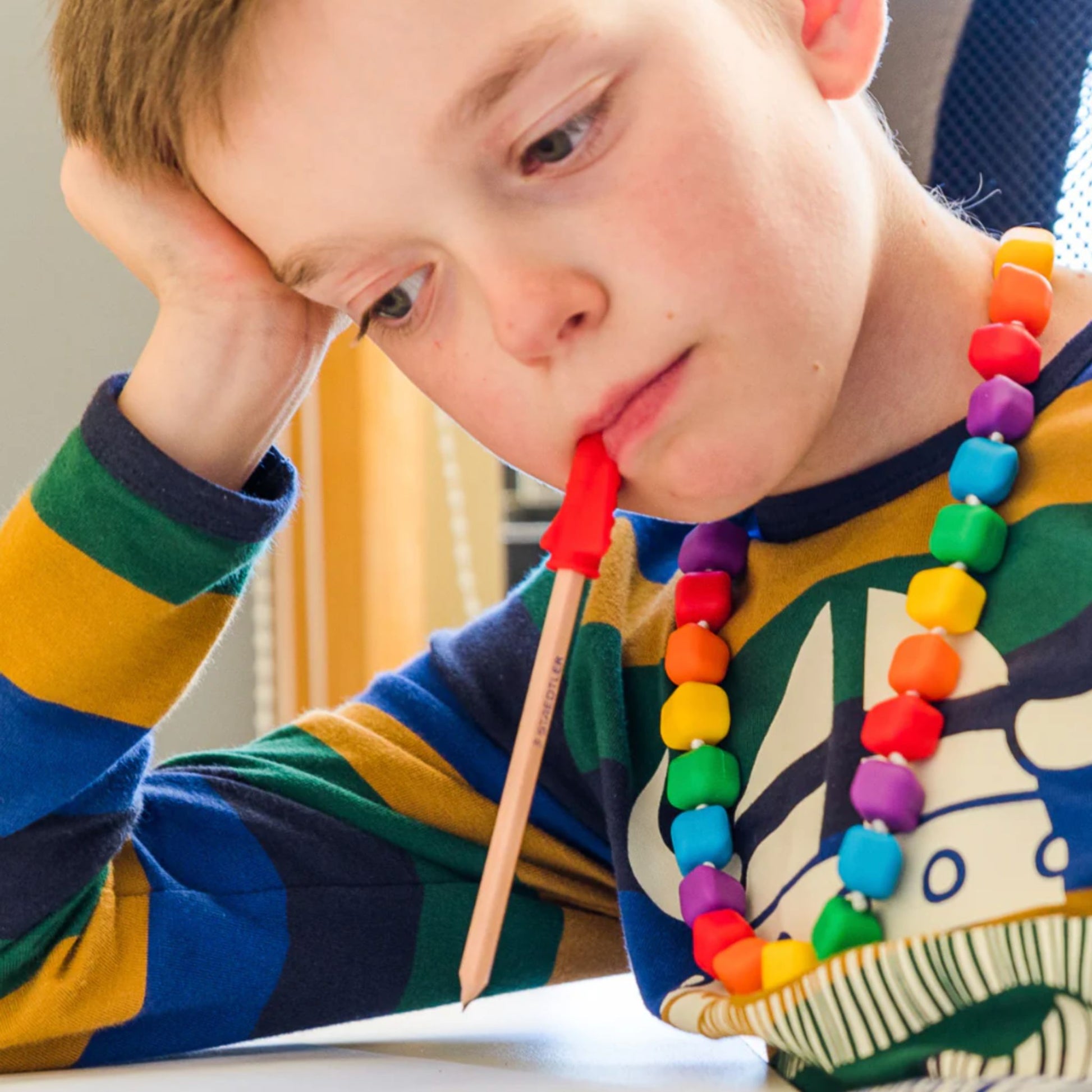 Child wearing Jellystone Designs Chew Necklace Princess the Pea in Rainbow Bright