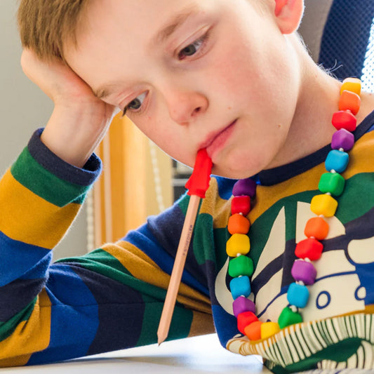 Child wearing Jellystone Designs Chew Necklace Princess the Pea in Rainbow Bright