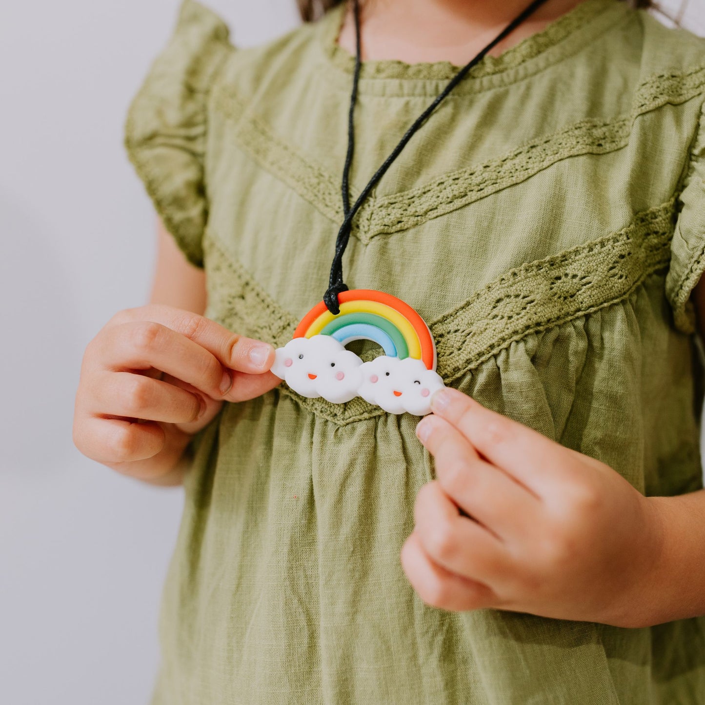 Child wearing Jellystone Designs Chew Necklace Rainbow in Bright