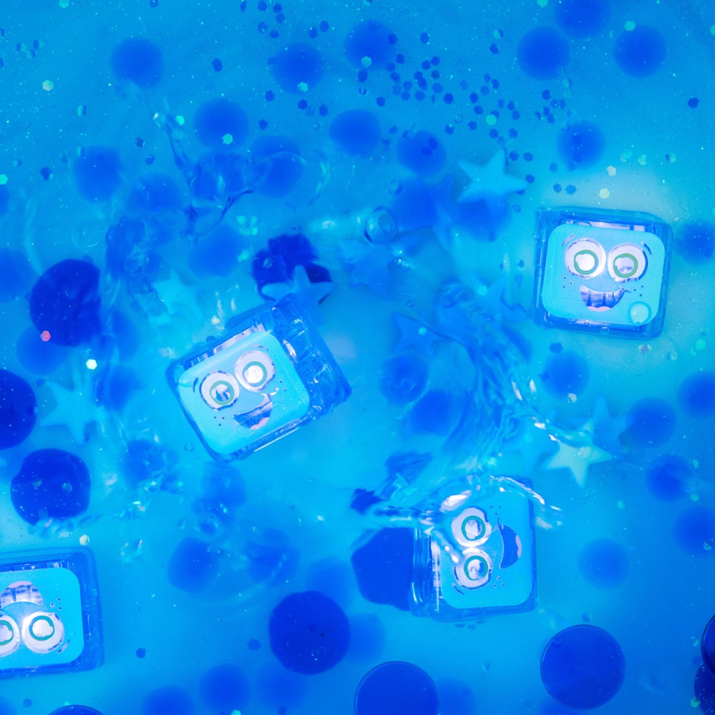 Blue water-activated sensory lights faces and bubbles on a blue background