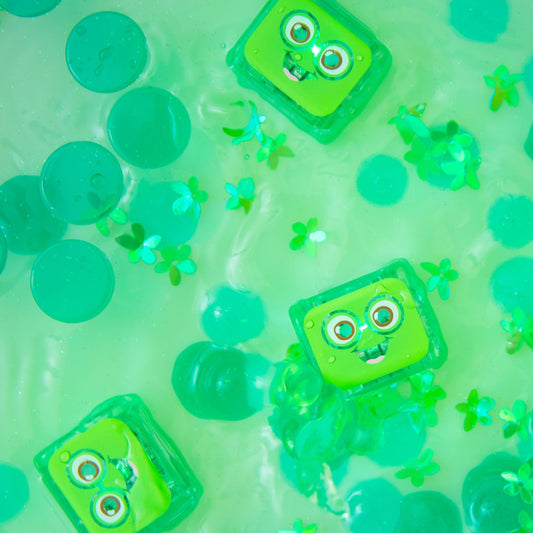 Jellystone Designs Glo Pal Cubes in Green or Pippa glowing in water - Water-activated sensory lights for sensory play