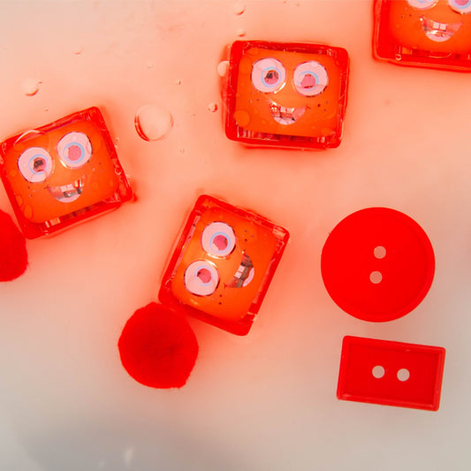 Red water-activated sensory lights with face-like designs in water