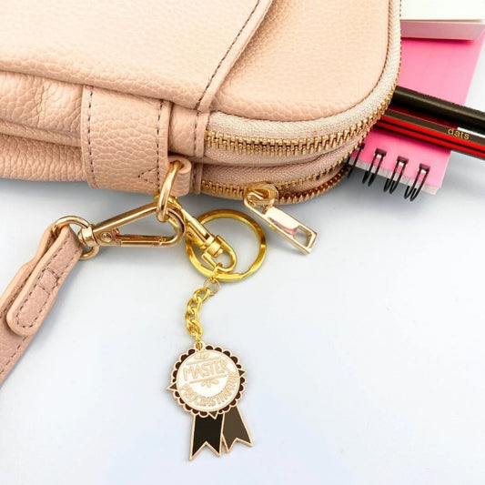 Jubly Umph Master Procrastinator Keychain attached to a bag