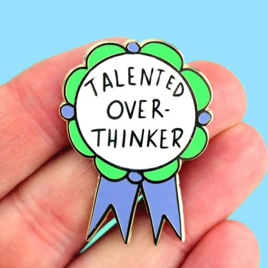 Hand holding a Jubly Umph Talented Over Thinker Lapel Pin