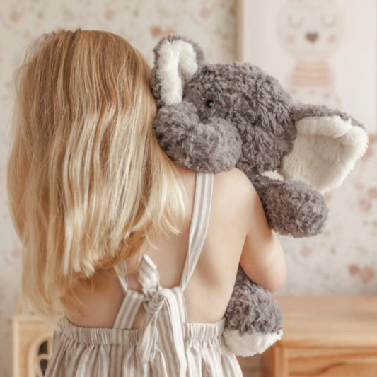 Girl cuddling a Mindful & Co Kids weighted plush toy - Eleanor the Weighted Elephant