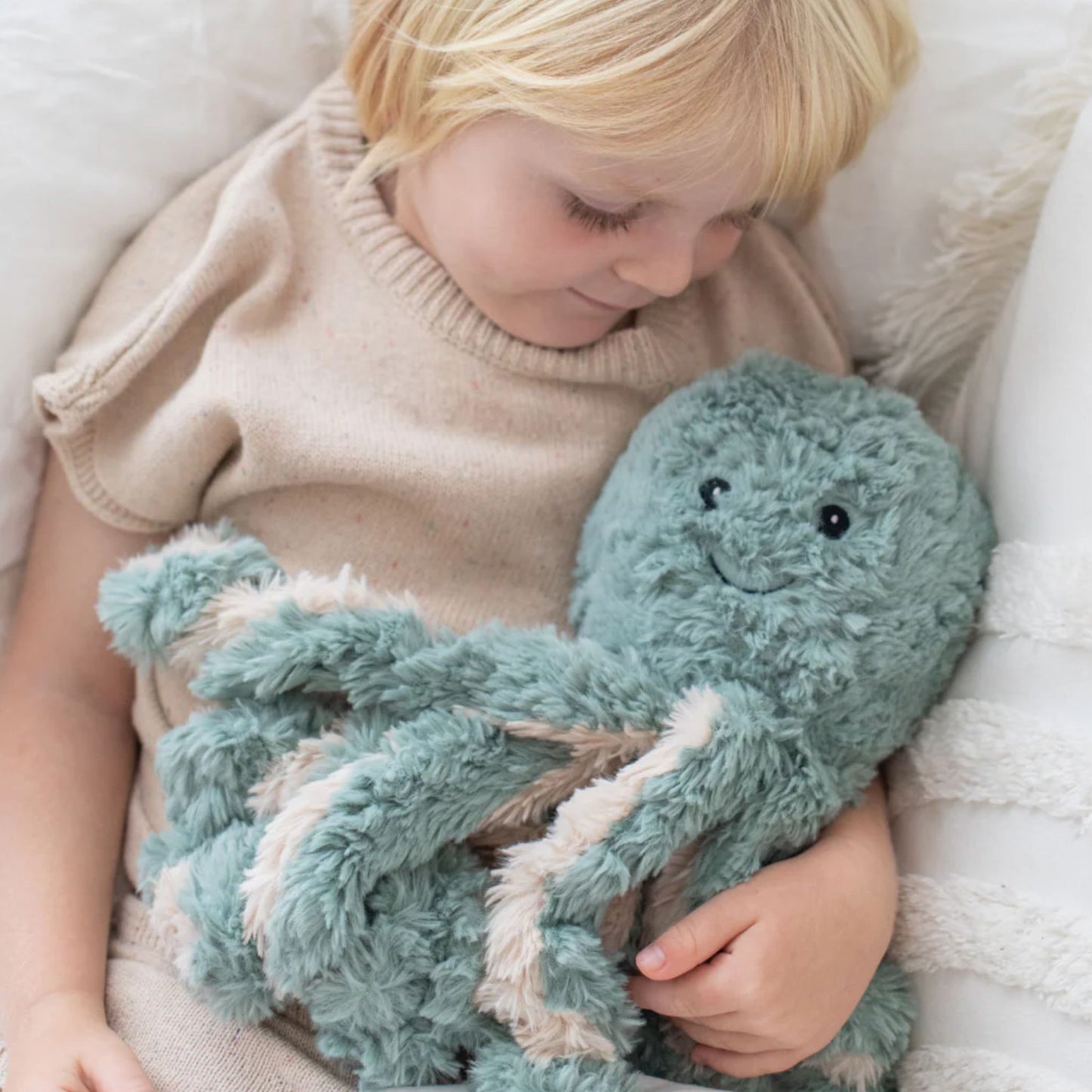 Child holding Girl hugging Ollie the Weighted Octopus weighted stuffed plush
