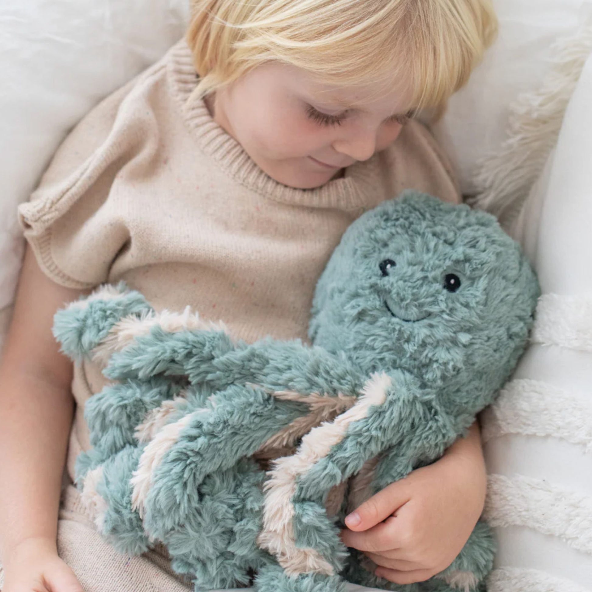 Child holding Girl hugging Ollie the Weighted Octopus weighted stuffed plush