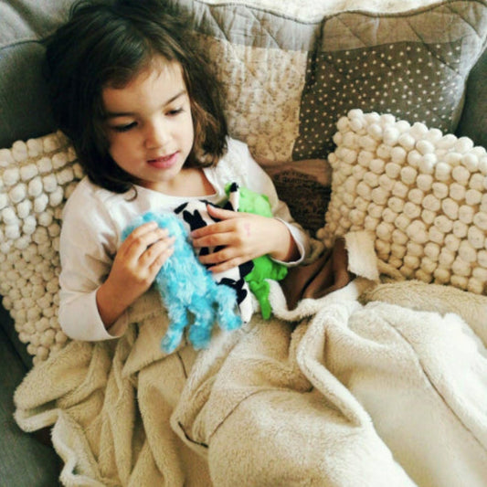 Child holding the Senseez Soothables Sensory Massager in the Lil Jelly pattern