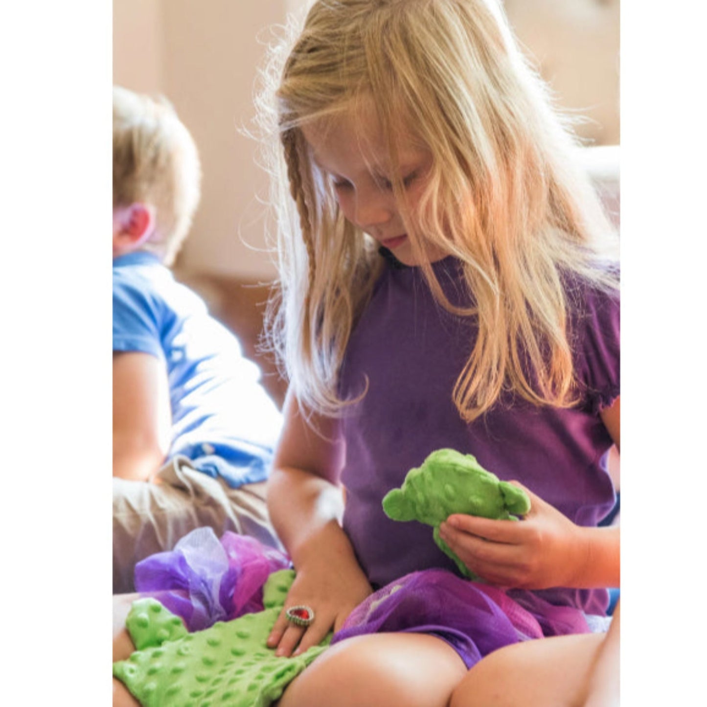 Child holding the Senseez Soothables Sensory Massager in the Lil Turtle pattern