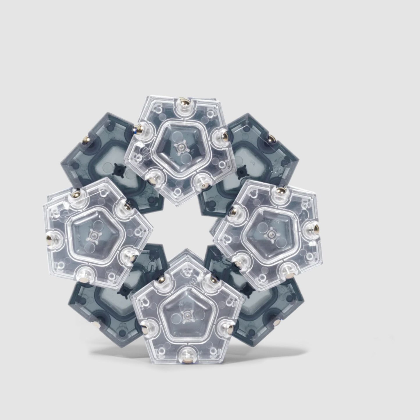 Speks Geode magnetic fidget in a hexagonal structure on a light grey background
