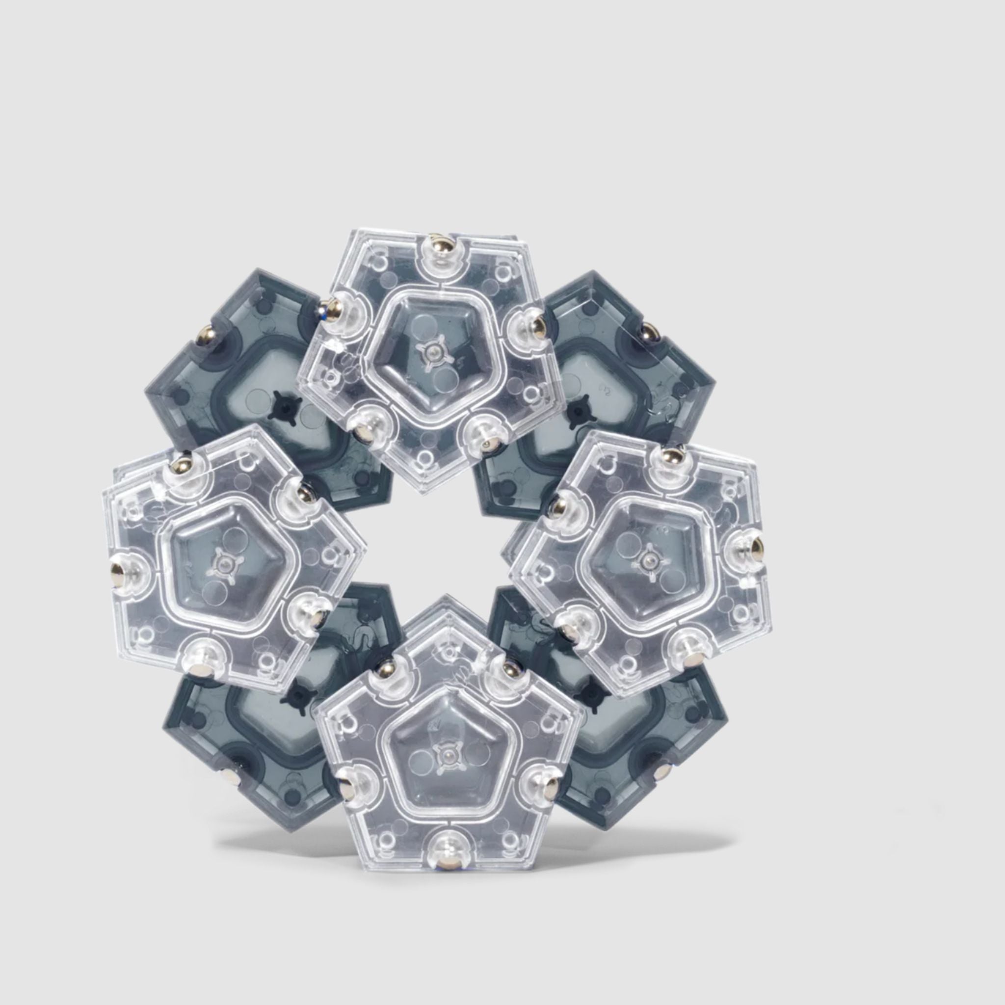 Speks Geode magnetic fidget in a hexagonal structure on a light grey background