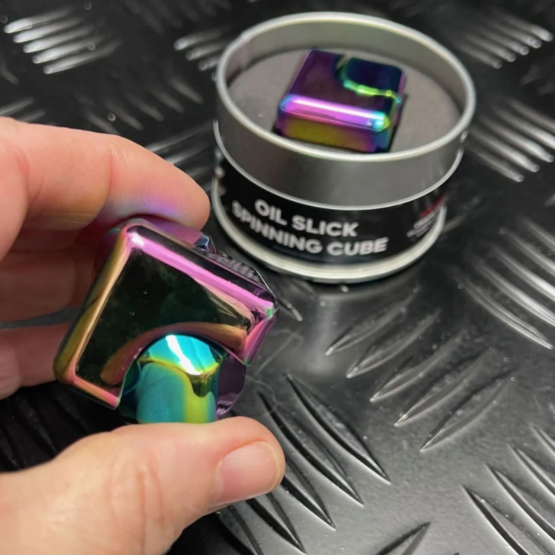 Hand holding Square Spinning Cube by Kaiko