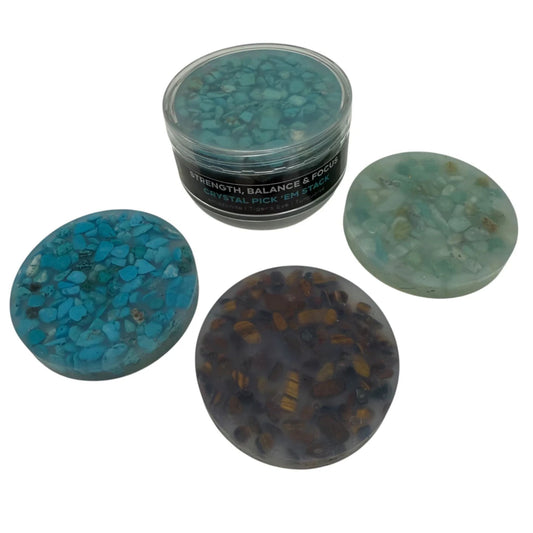 Three Kaiko turquoise crystals and stone silicone picking pads and a container labeled 'Strength, Balance & Power' on a white background
