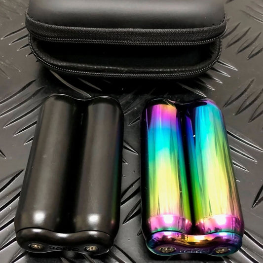 Two metal hand rollers fidgets from Kaiko Fidgets - one black and one oil slick on a textured surface