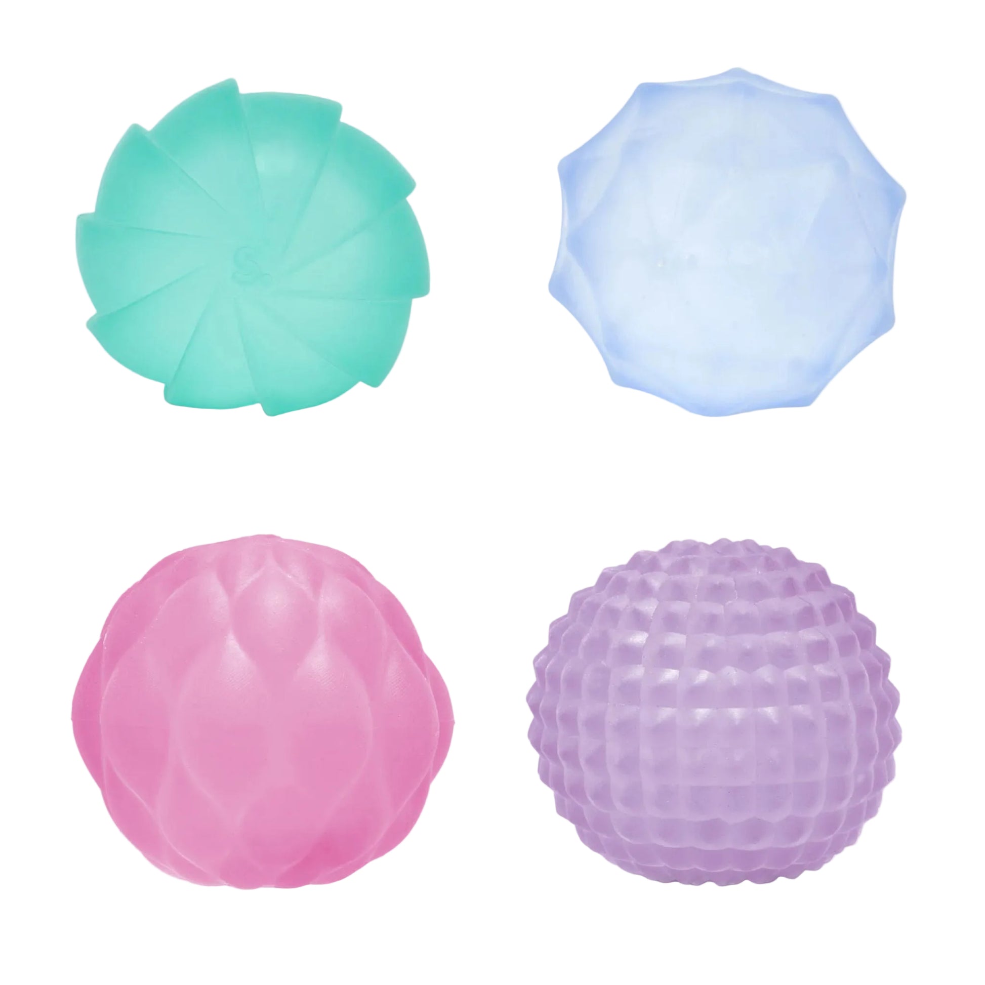 Four textured stress balls arranged in a 2x2 grid on a white background: a mint green fan-shaped ball, a light blue faceted ball, a pink smooth ball, and a purple dimpled ball.