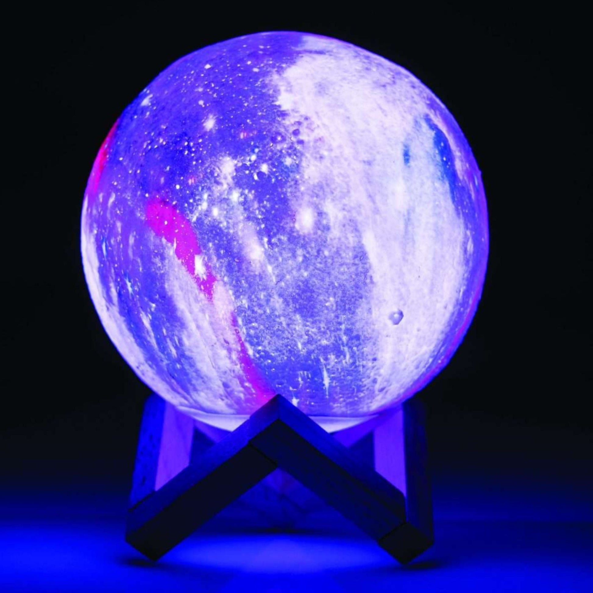 Glowing purple and blue spherical Moon Lamp on a stand against a dark background