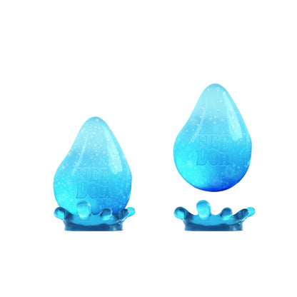 Blue NeeDoh Dream Drop squishy ball in and out of the splash stand on a white background
