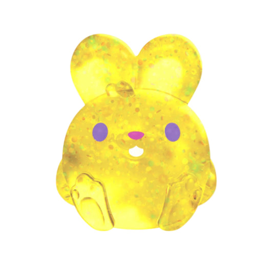 Yellow rabbit-shaped Needoh squishy with purple eyes on a white background