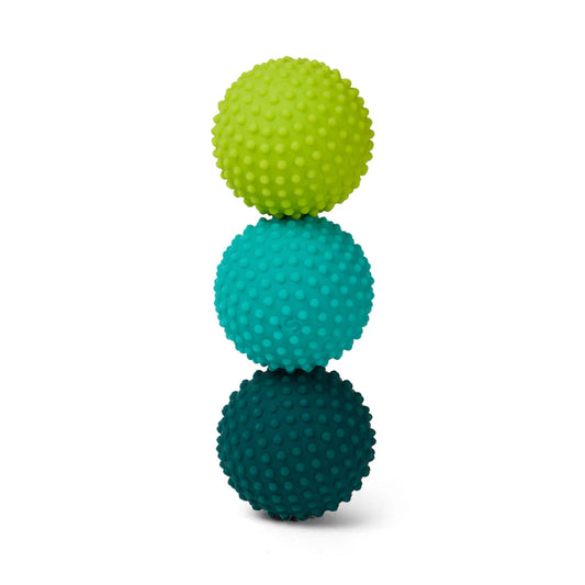 Three Speks Odds rubberised textured silicone balls stacked on a white background