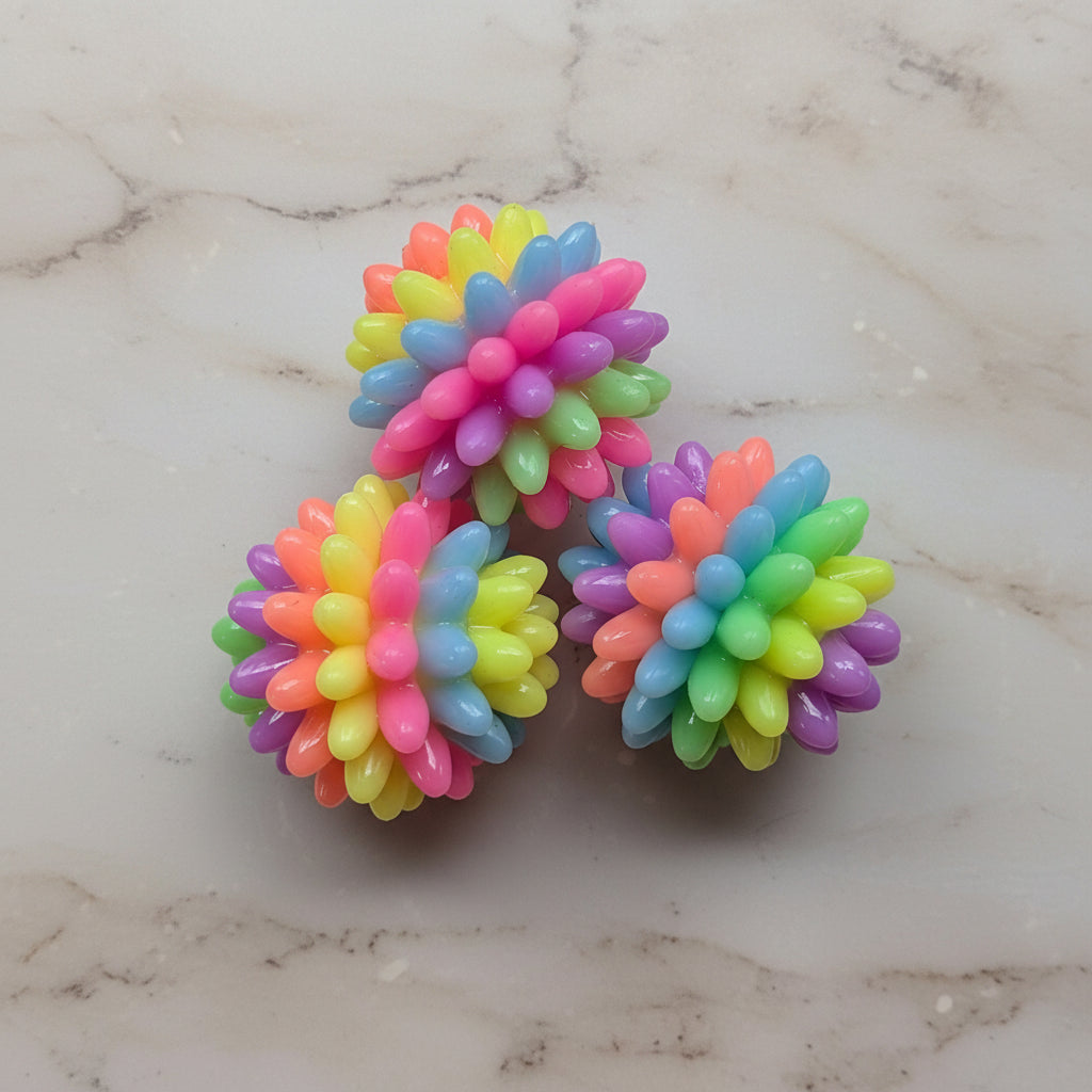 Colorful textured balls on a marble surface