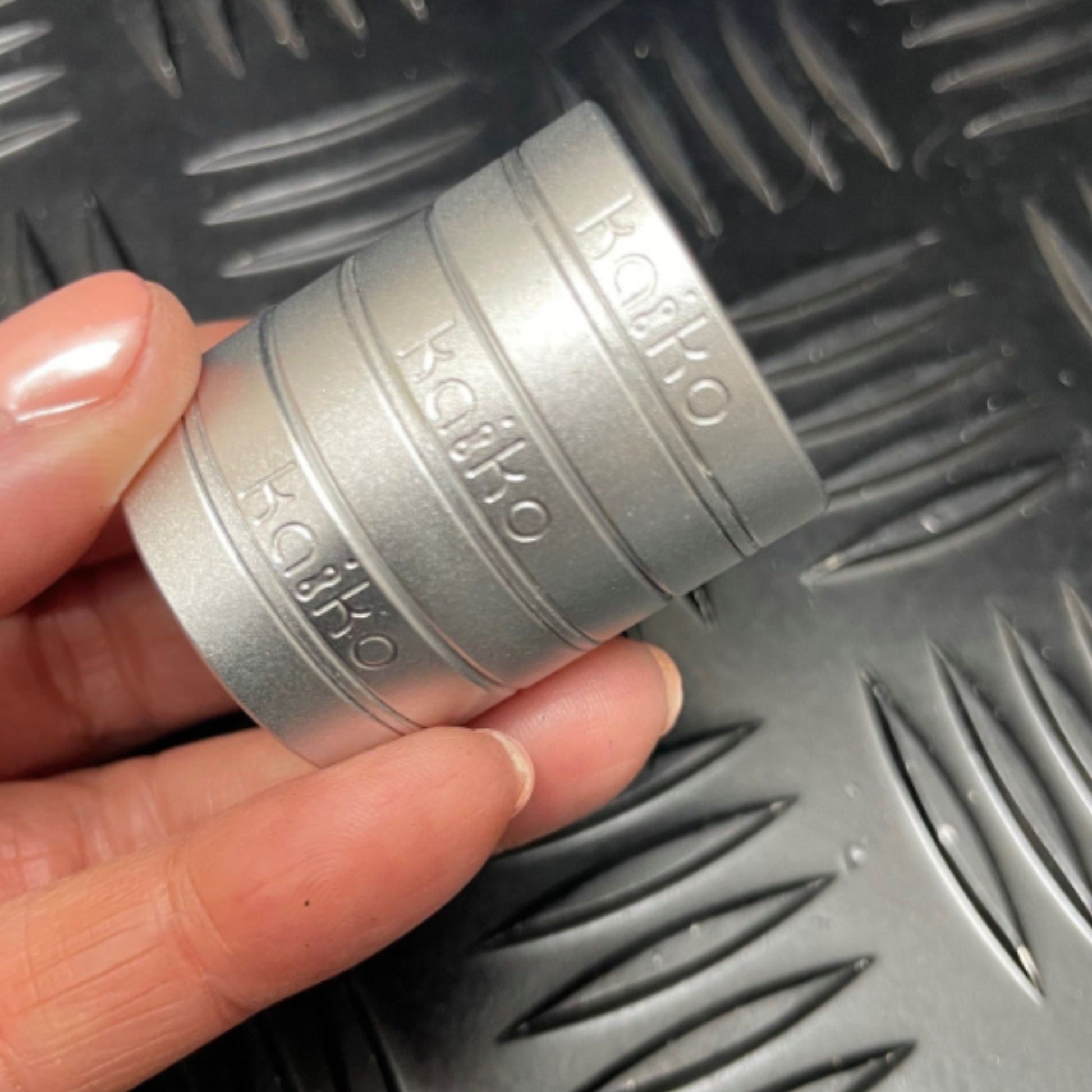 Hand holding Kaiko's Tri Magnetic Fidget Rings stacked together