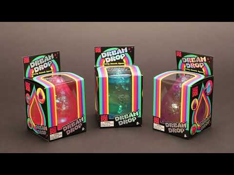 Demonstration of NeeDoh Dream Drop squishy balls in purple, blue and pink colours on a dark background