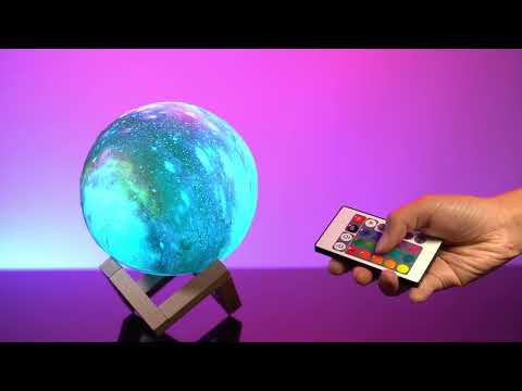 Demonstration video of a glowing purple and blue spherical Galaxy Moon Lamp on a stand against a dark background